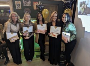 A photo of five Daniel Gray Team Members each holding a certificate.